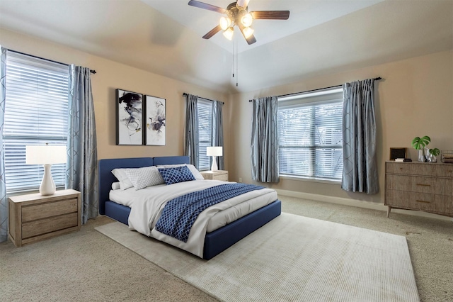 carpeted bedroom featuring a ceiling fan, vaulted ceiling, and baseboards