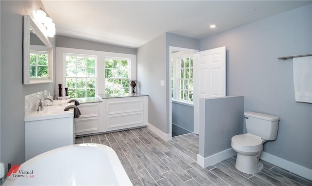 bathroom featuring hardwood / wood-style floors, vanity, and toilet