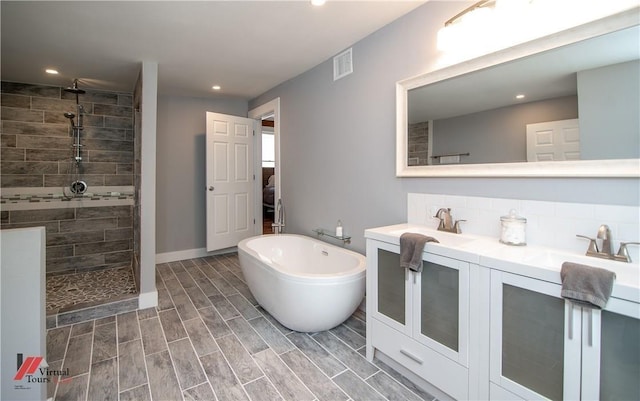 bathroom featuring vanity and plus walk in shower