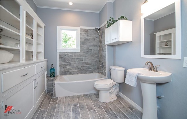 bathroom with crown molding, tiled shower / bath combo, and toilet