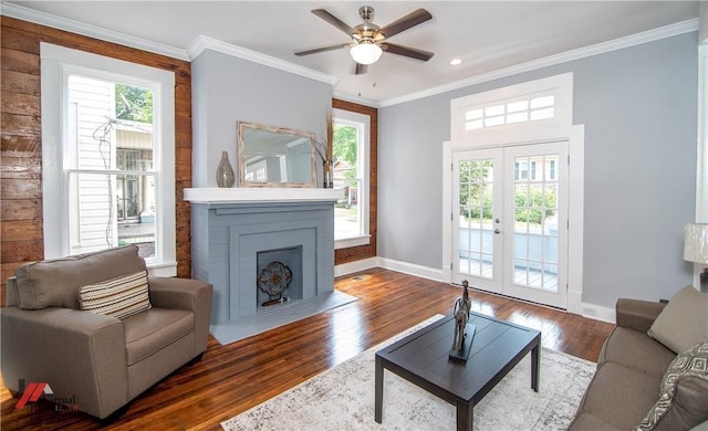 living room with french doors, dark wood-type flooring, ceiling fan, and crown molding