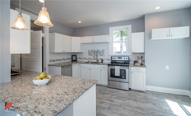 kitchen with tasteful backsplash, stainless steel appliances, sink, white cabinets, and hanging light fixtures