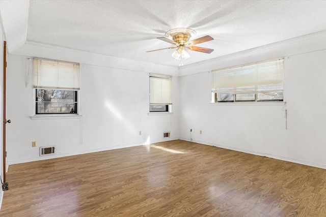 spare room with ceiling fan, hardwood / wood-style flooring, and a textured ceiling