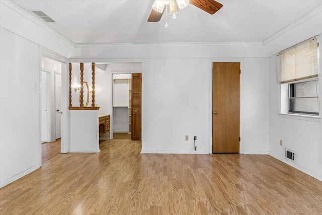 empty room featuring ornamental molding, a textured ceiling, ceiling fan, and light hardwood / wood-style floors