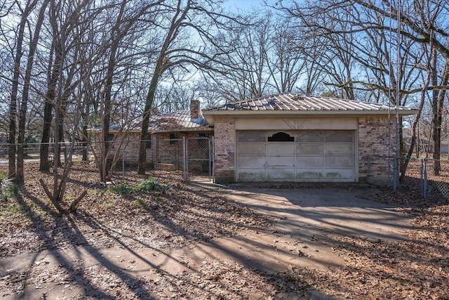 ranch-style home with an outbuilding and a garage