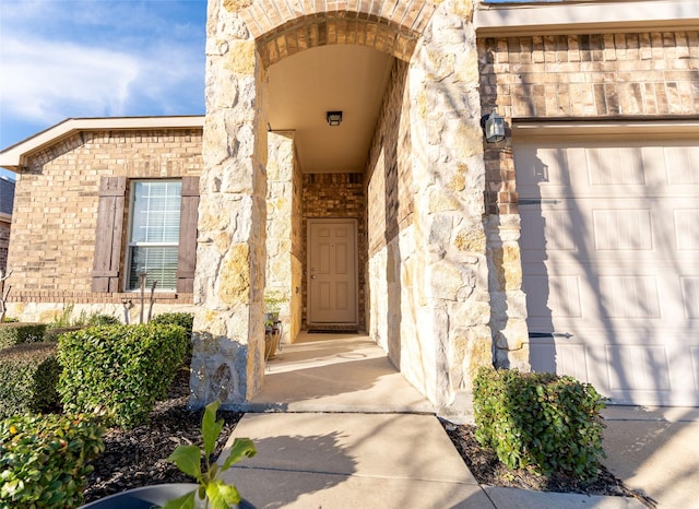 doorway to property with a garage