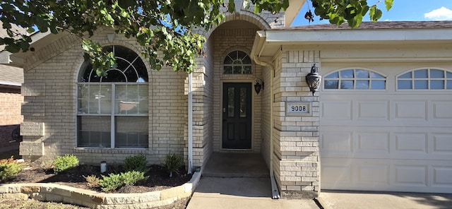 view of exterior entry with a garage