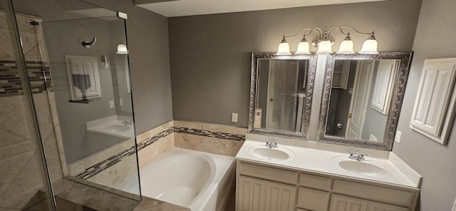 bathroom with vanity and shower with separate bathtub