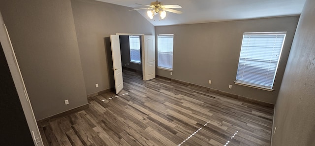 unfurnished bedroom featuring ceiling fan, lofted ceiling, and dark hardwood / wood-style flooring