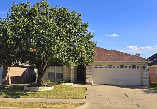 view of front of home with a garage and a front lawn