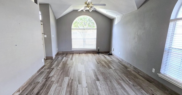 interior space with ceiling fan, lofted ceiling, and light hardwood / wood-style flooring