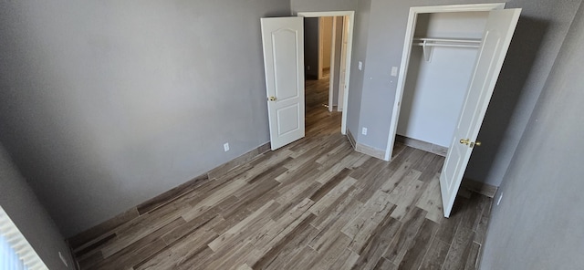 unfurnished bedroom featuring light hardwood / wood-style flooring and a closet