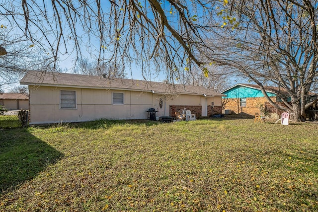 rear view of property with a lawn