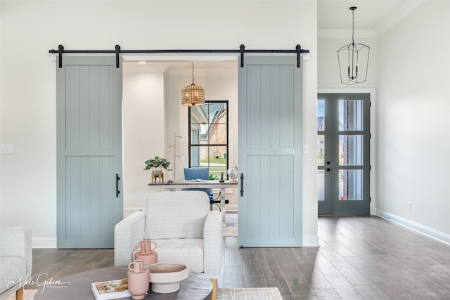 interior space with crown molding, a barn door, and hardwood / wood-style flooring