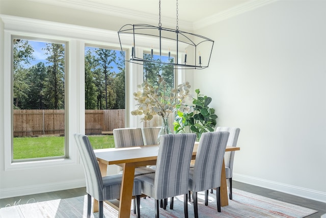 dining room featuring hardwood / wood-style flooring, crown molding, and a chandelier