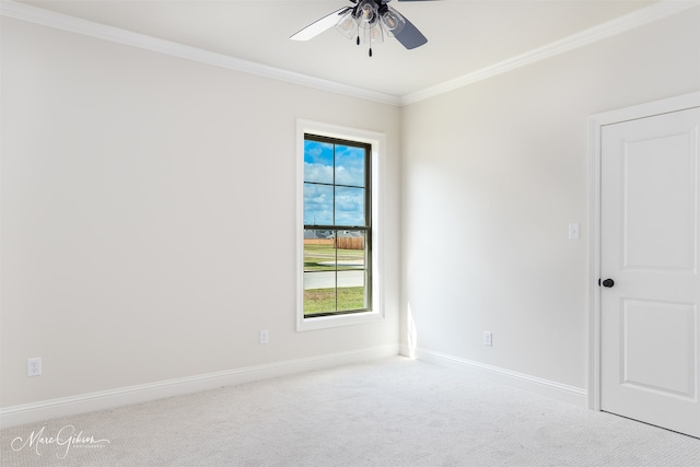 carpeted spare room with crown molding and ceiling fan