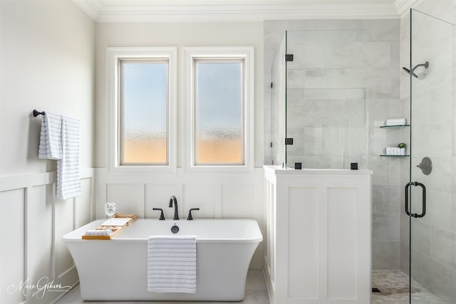 bathroom with ornamental molding and separate shower and tub