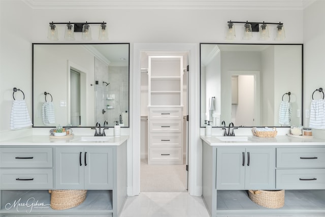 bathroom with vanity, ornamental molding, and tiled shower