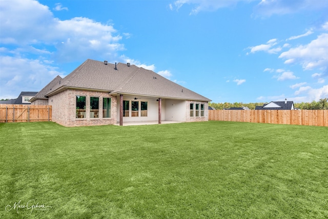 back of house featuring a patio, ceiling fan, and a lawn