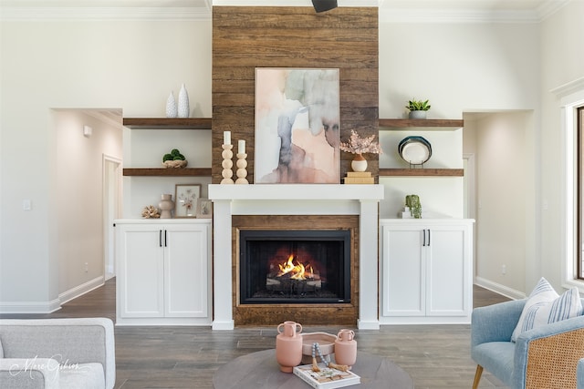 living area with dark wood-type flooring and ornamental molding