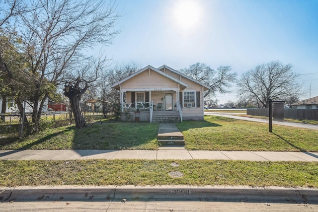 bungalow featuring a front lawn and a porch