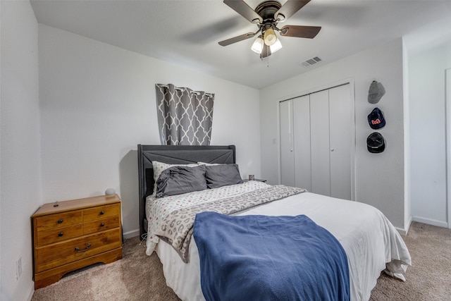 carpeted bedroom featuring ceiling fan and a closet