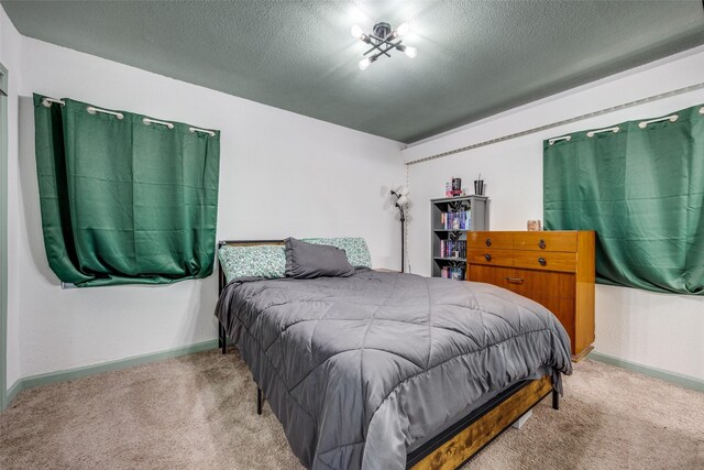 carpeted bedroom featuring a textured ceiling