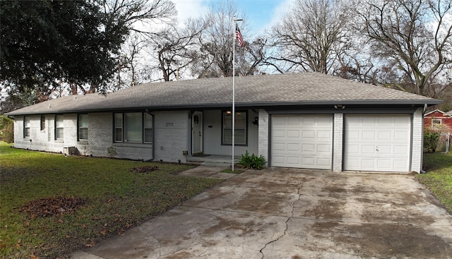 single story home featuring a garage and a front lawn