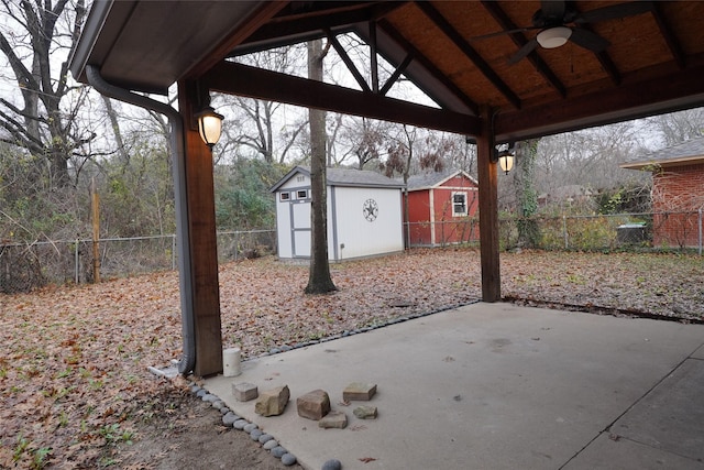 view of patio featuring a gazebo, a shed, and ceiling fan