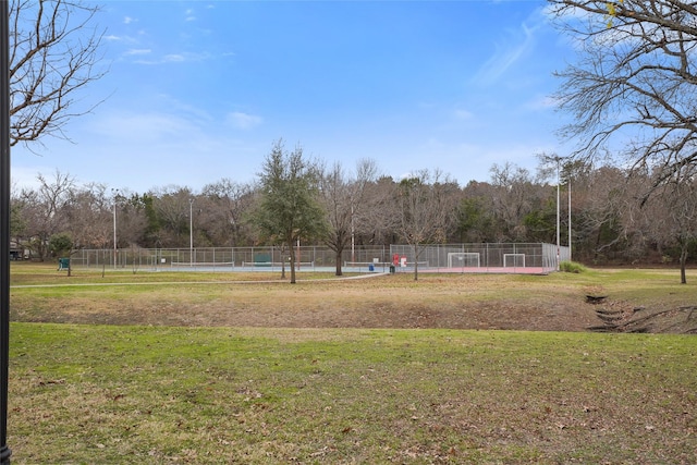 view of property's community with a pool and a yard