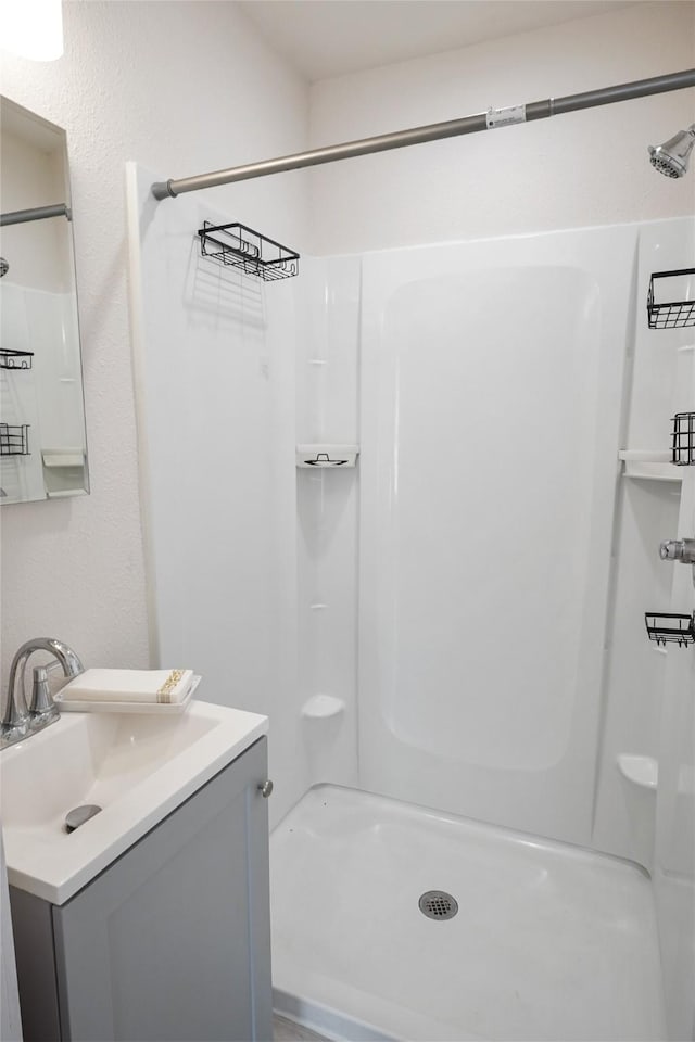 bathroom with a shower and vanity