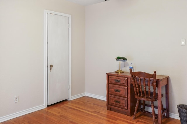 home office with light hardwood / wood-style floors