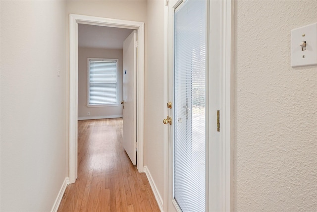 corridor featuring light hardwood / wood-style floors