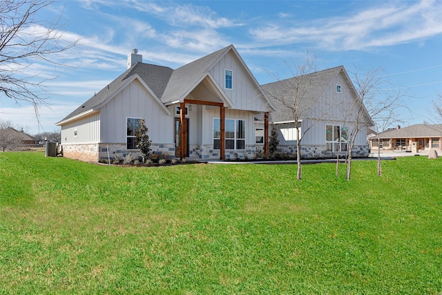 back of house featuring a yard and central AC