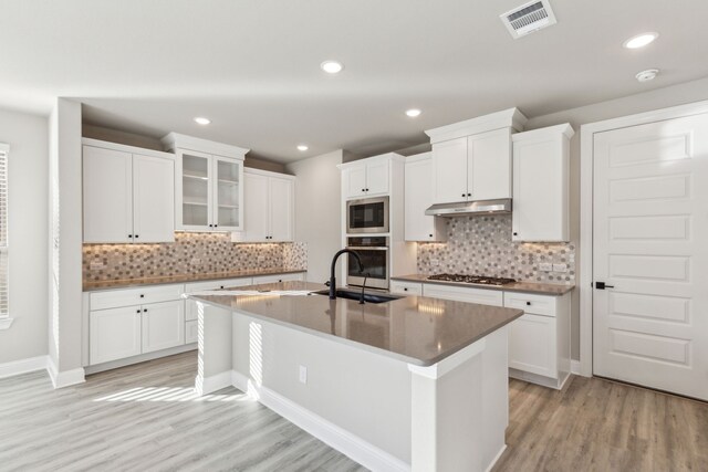 kitchen featuring stainless steel appliances and white cabinetry