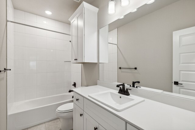 full bathroom with tile patterned floors, toilet, vanity, and tiled shower / bath