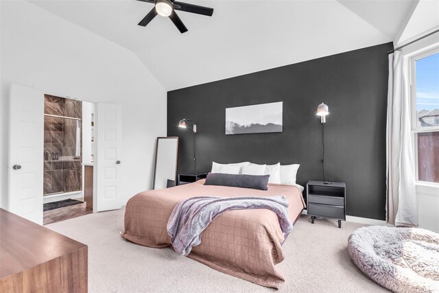 carpeted bedroom with lofted ceiling, connected bathroom, and ceiling fan