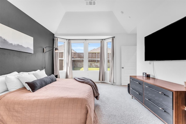 carpeted bedroom with lofted ceiling