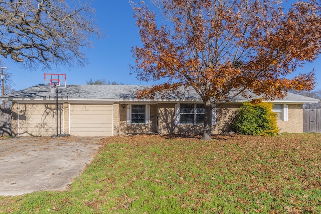 single story home with a garage and a front lawn