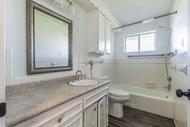 full bathroom featuring shower / bath combination, vanity, wood-type flooring, and toilet