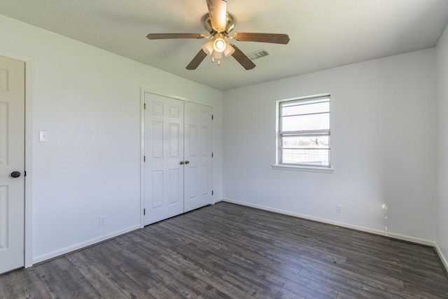 unfurnished bedroom featuring ceiling fan, a closet, and dark hardwood / wood-style floors