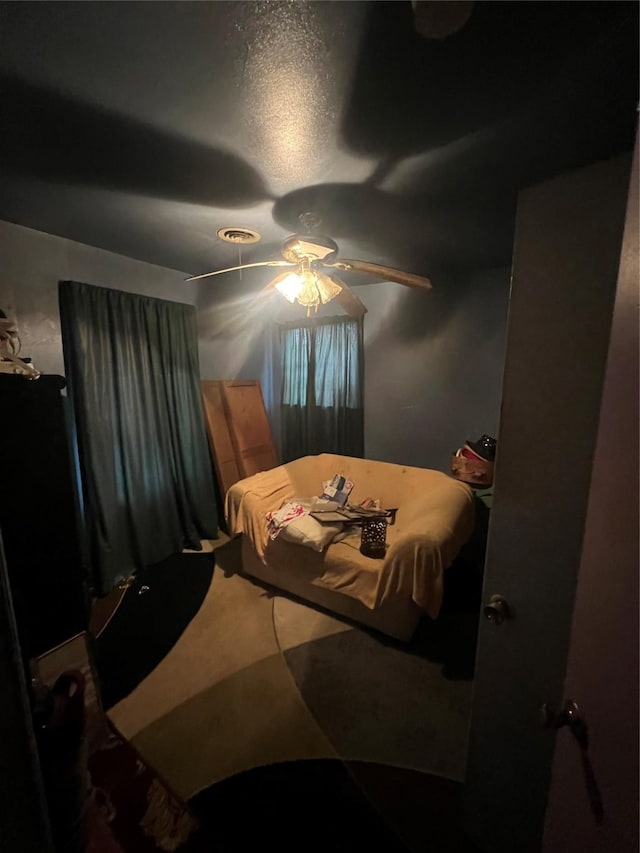 bedroom featuring ceiling fan and carpet floors