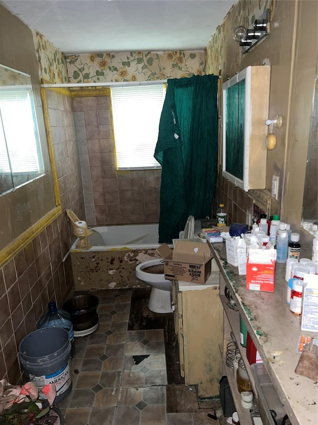 full bathroom featuring vanity, shower / bath combination with curtain, tile walls, and toilet