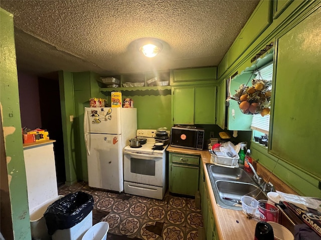 kitchen featuring a textured ceiling, sink, white appliances, and green cabinetry