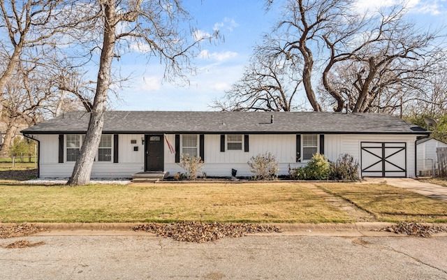 ranch-style house with a garage and a front lawn