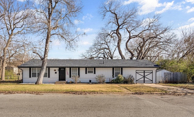 single story home featuring a front yard and a garage