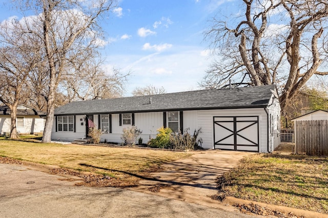 ranch-style home featuring a garage and a front yard