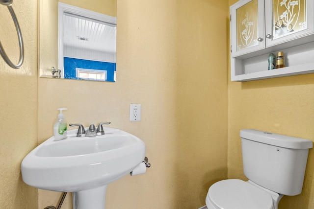 bathroom with toilet and sink