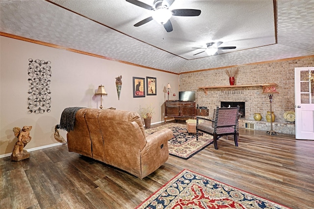 living room with hardwood / wood-style floors, a textured ceiling, ceiling fan, and crown molding