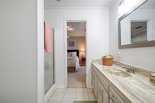 full bathroom featuring connected bathroom, a stall shower, tile patterned flooring, vanity, and ornamental molding